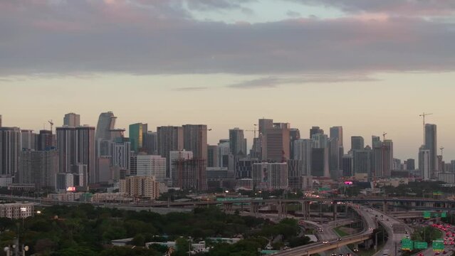 Establishing aerial shot of the city of Miami i95 skyline at sunset with clouds in the sky. Concept of travel in Miami Florida.High quality 4k footage 