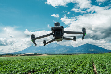 Aerial view of a drone moderning over farm fields, monitoring, analyzing crop health. Agricultural...