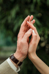 Close up of the hands of a boy and girl. They are holding hands, romantic