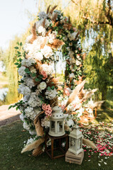 Wedding. Wedding ceremony. Arch decorated with pink and white flowers in the wedding ceremony area
