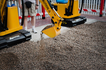 Mini excavator at the construction site. Compact construction equipment for earthworks