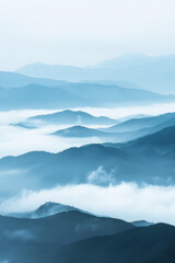 Obraz premium A tranquil view of the layers of mountain ridges disappearing into misty clouds, with their soft outlines and muted colors.