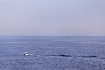 Photo of a boat in the ocean taken in the town of Benidorm in Spain in the ocean on the south...