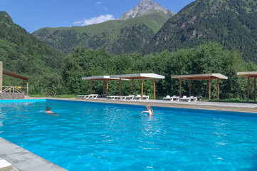 A heated pool high in the mountains. Relaxing by the water in the fresh air. Sun loungers for...