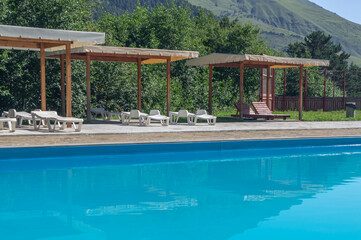 A heated pool high in the mountains. Relaxing by the water in the fresh air. Sun loungers for...