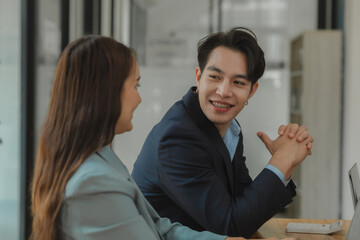 two employees are talking about an information of meeting report, colleagues are discussing and giving some advice to each other, happy workplace atmosphere, working together.
