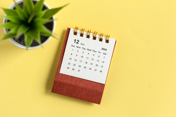 December 2024. Monthly desk calendar for 2024 on a yellow background.
