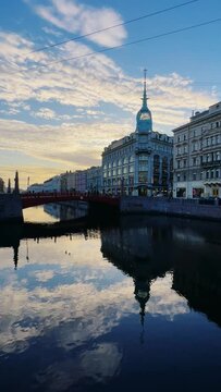 Russia, April 09, 2024: The channel in St. Petersburg in the spring. Bridges and historical buildings on the river embankment, people walking along the embankment. Reflections of houses in the water. 