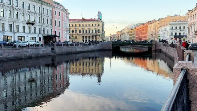 Russia, April 09, 2024: The channel in St. Petersburg in the spring. Bridges and historical buildings on the river embankment, people walking along the embankment. Reflections of houses in the water. 