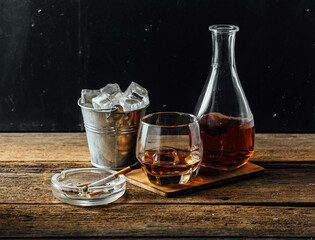 whiskey and ice on wooden background