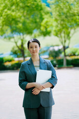 Confident Businesswoman Holding Tablet in Outdoor Setting