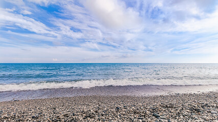 Summer sea beach landscape nature background wallpaper. Clear blue sea water on pebble beach....