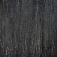 Black painted background image. Brush strokes in vertical direction creating a dark texture. Empty...