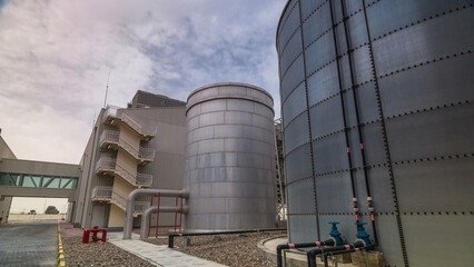 Obraz premium Two silver Water Tanks with fence timelapse hyperlapse