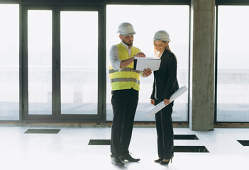 two architect engineers talking in a constructed office building. implementation of the project