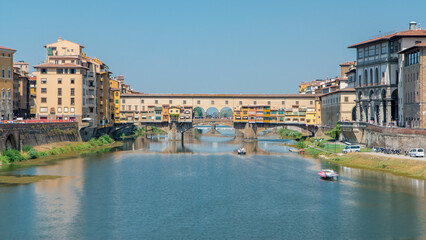 The Ponte Vecchio on a sunny day timelapse, a medieval stone segmental arch bridge over the Arno River in Florence, Italy