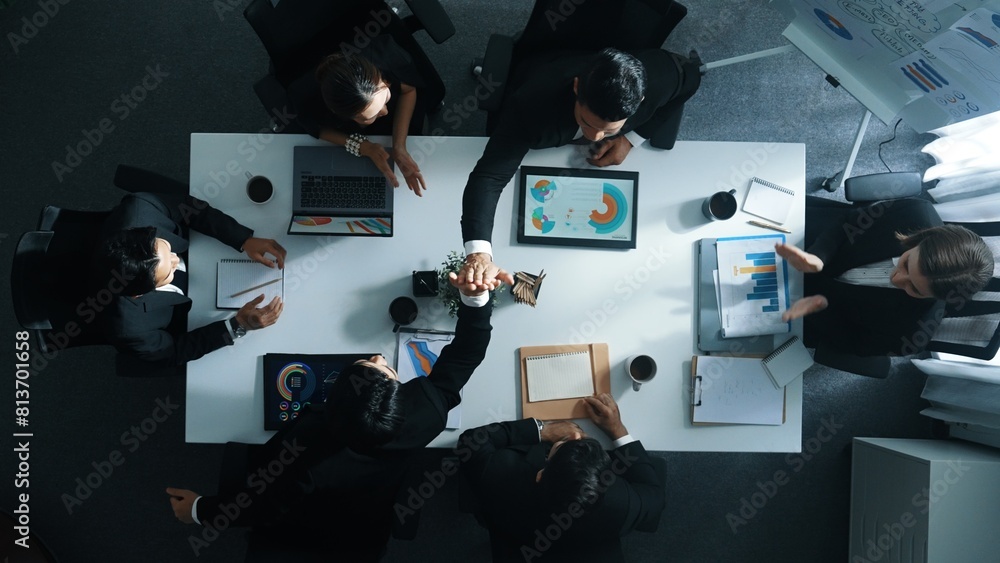 Aufkleber top down aerial view of smart manager pointing at financial graph on whiteboard while diverse busine