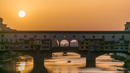 Sunset view of Florence Ponte Vecchio over Arno River in Florence timelapse, Italy.