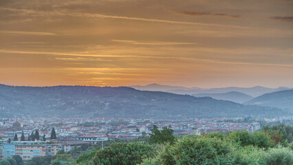 Sunrise top view of Florence city timelapse with arno river bridges and historical buildings