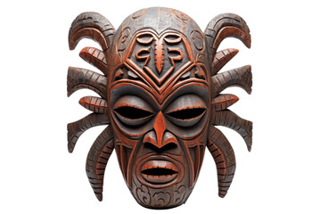 A carved wooden mask with a spidery face and horns. The mask is brown and has a creepy, menacing look to it