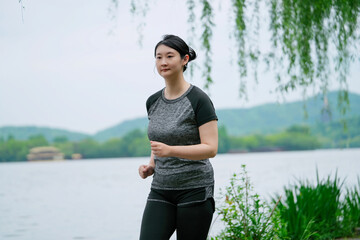 Young Woman Enjoying a Peaceful Lakeside Run