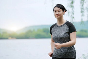Young Woman Enjoying a Lakeside Morning Jog