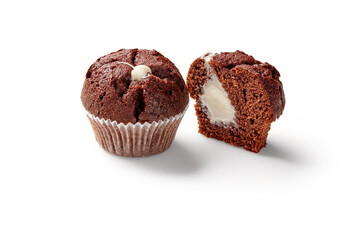 Whole and sliced chocolate muffins with creamy filling