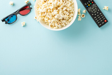 Home entertainment delight: top view of crunchy popcorn, 3D glasses, and remote control for...