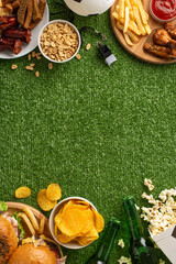 Sports celebration platter. Vertical top view of football snacks: crispy chips, salted nuts, fluffy...
