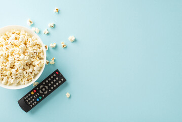 Enjoy home cinema with premieres using TV app. Top-view shot of popcorn, and remote for online...