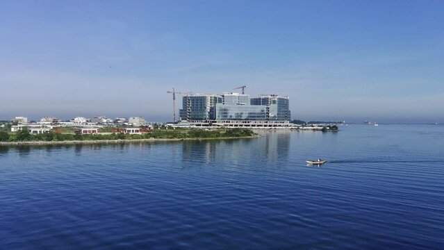 Drone video of the sea in the morning when a boat passes by