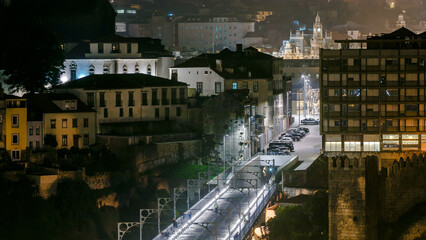 City of Porto by night timelapse in Portugal, the Old Town and Ponte Dom Luiz I arch bridge over Douro river.