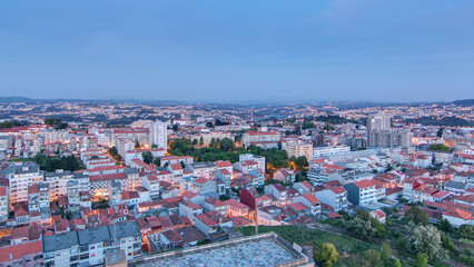 Obraz premium Rooftops of Porto's old town on a warm spring evening timelapse day to night, Porto, Portugal