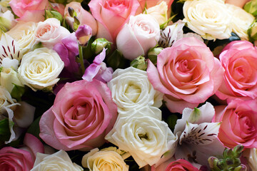 Beautiful floral background of white and pink roses. Photo of a bouquet in a flower shop