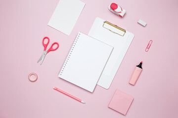 Creative flat lay mockup design of workspace. Top view composition with white notebook, to do list and stationery on pink background