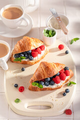 Golden and healthy french croissant with berries and cottage cheese.