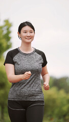Confident Young Woman Enjoying Morning Jog in Park