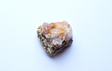 Beautiful druse of natural rose mineral quartz on a white background. Healing chakra crystals.
