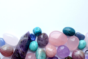 Multicolored healing chakra crystals.  Copy space. Real semi-precious stones: rose quartz, ...
