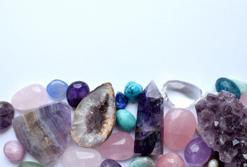 Multicolored healing chakra crystals.  Copy space. Real semi-precious stones: rose quartz, ...