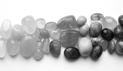 Healing chakra crystals, monochrome photo. Real semi-precious stones: rose quartz, amethyst, citrine, agate, apatite, kyanite, fluorite.