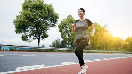 Active Woman Enjoying Morning Run on Track