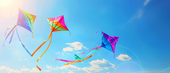 Three colorful kites flying in the sky on a sunny day. The kites are of different colors and sizes. Concept of joy and freedom. rainbow coloured kites with rainbow ribbons flying in the sky, sunny day
