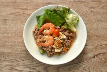 spicy chop pork Thai chili pasted topping boiled shrimp and salty egg eat couple fresh vegetable on plate 
