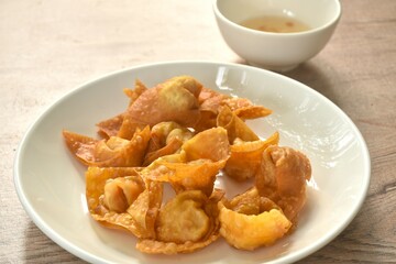 crispy fried dumpling paste stuffed chop pork and shrimp dipping sweet chili sauce on plate