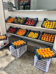 a shelf of fruit including apples oranges and lemons pineapple juice bar concept store interior