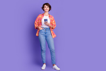 Full size photo of pretty young girl use smart phone wear shirt isolated on violet color background
