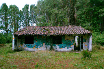 Abandoned house in the middle of the forest. Concept of an abandoned building in the middle of a lonely and cold forest.