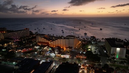 Fototapeta premium Sunset Skyline At Oranjestad Caribbean Netherlands Aruba. Aerial Beach Oranjestad Caribbean Netherlands. Construction Landscape Company Building Beauty.