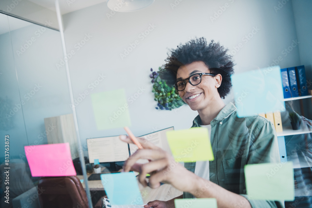 Canvas Prints Photo of handsome cool assistant dressed khaki shirt glasses writing ideas memo stickers indoors workstation workplace